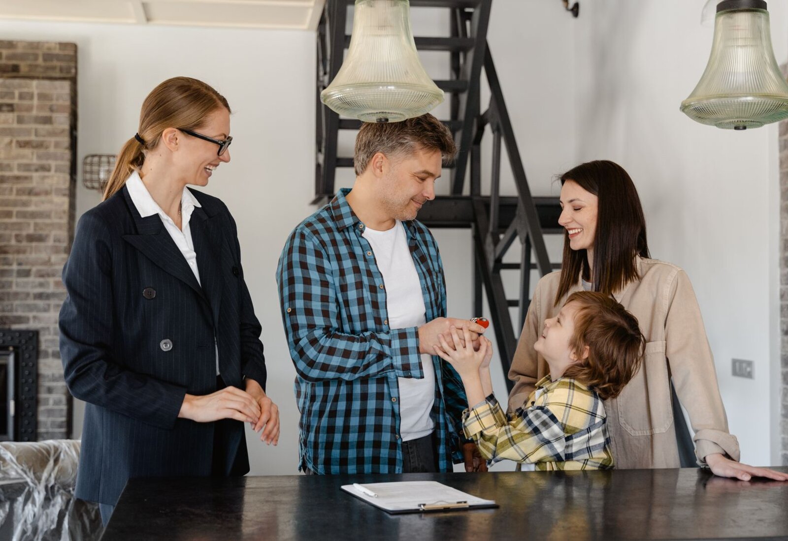A happy family being handed the keys to their new home